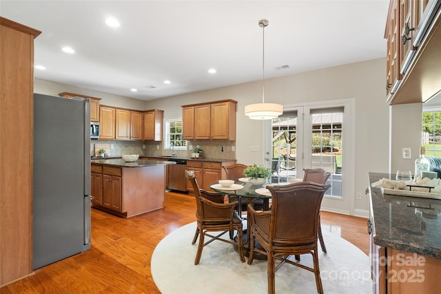 dining room with light wood-style flooring, recessed lighting, and visible vents