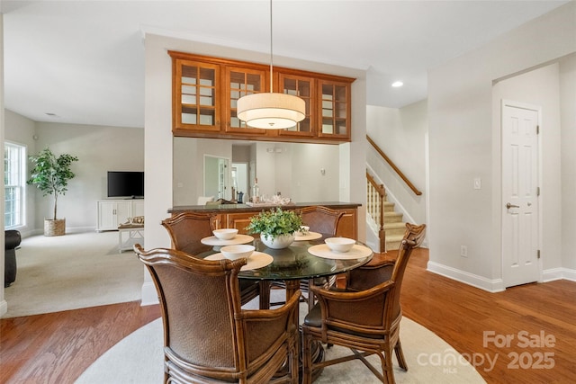 dining space featuring stairway, recessed lighting, baseboards, and light wood finished floors