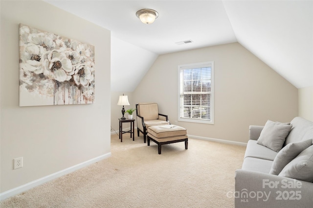 sitting room with vaulted ceiling, baseboards, visible vents, and carpet floors