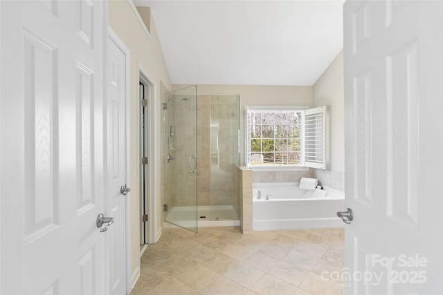 bathroom with tile patterned flooring, a shower stall, and a bath