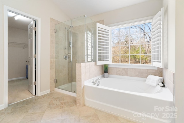 bathroom with vaulted ceiling, a spacious closet, a bath, and a stall shower