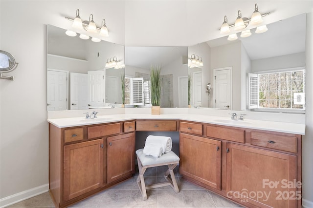 full bathroom featuring double vanity, tile patterned floors, and a sink