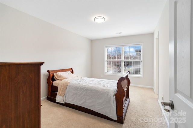 bedroom featuring light colored carpet, visible vents, and baseboards