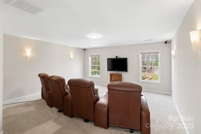 home theater room featuring light carpet, visible vents, and baseboards