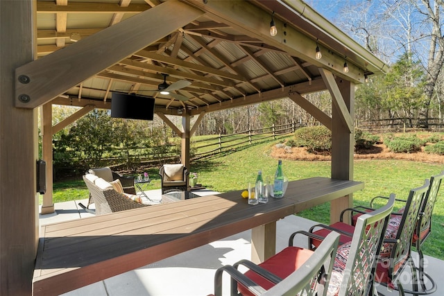 view of patio with a gazebo, fence, and ceiling fan