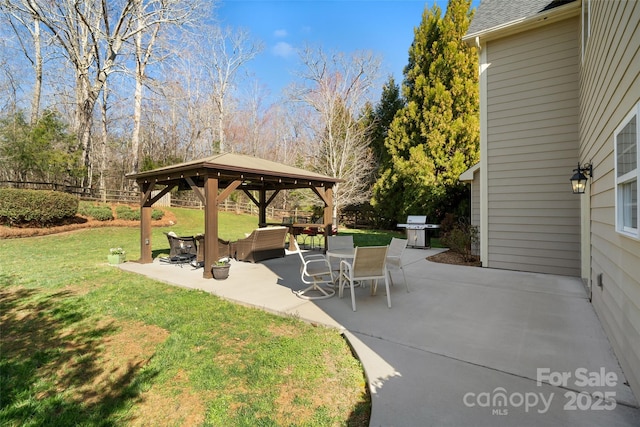 view of patio with a gazebo, a grill, and fence