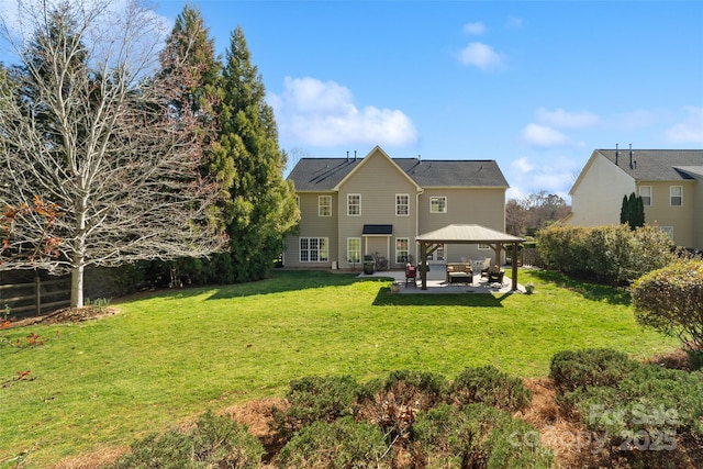 rear view of property featuring a gazebo, a yard, a patio, and fence