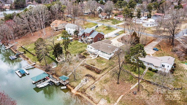 birds eye view of property with a water view and a residential view