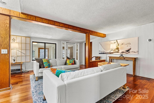 living area with hardwood / wood-style flooring and a textured ceiling