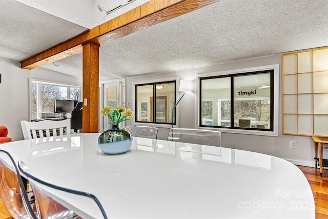 dining room featuring a textured ceiling and wood finished floors