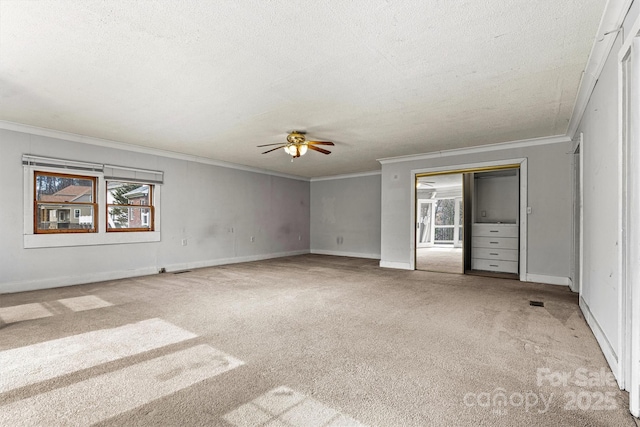 unfurnished bedroom with carpet floors, multiple windows, ornamental molding, and a textured ceiling