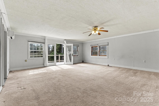 spare room with light carpet, an AC wall unit, ornamental molding, and baseboards