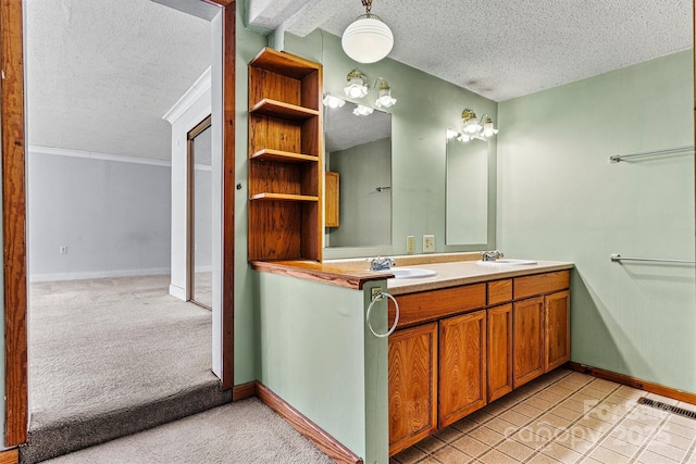 full bathroom featuring visible vents, a sink, a textured ceiling, and double vanity