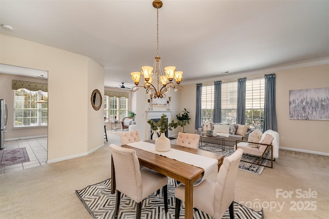 dining area with baseboards, light colored carpet, an inviting chandelier, and ornamental molding