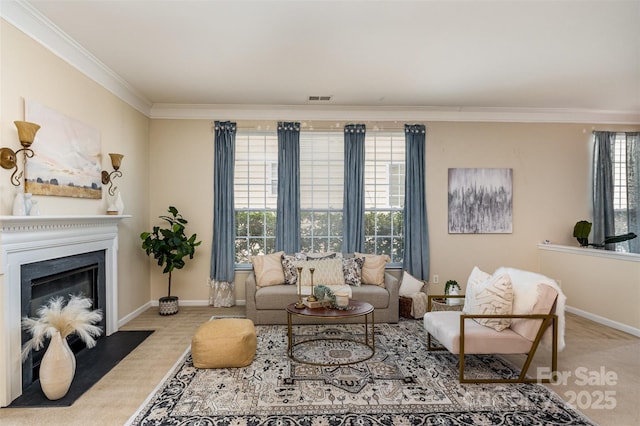 living area featuring a fireplace with flush hearth, crown molding, baseboards, and carpet floors