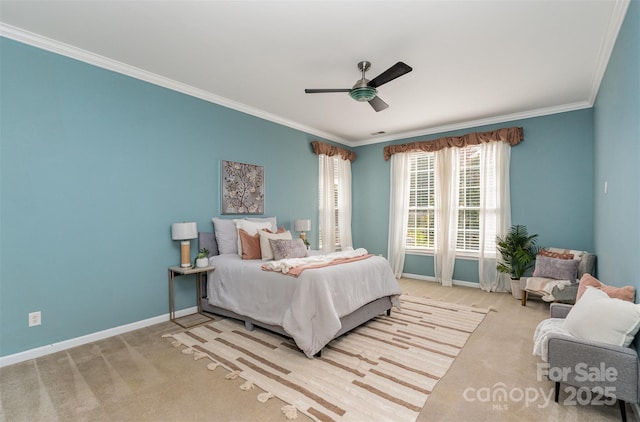 carpeted bedroom featuring ceiling fan, baseboards, and ornamental molding