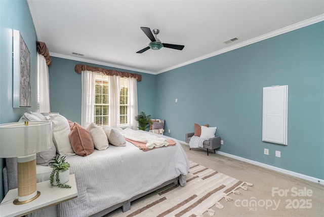 carpeted bedroom with a ceiling fan, crown molding, baseboards, and visible vents