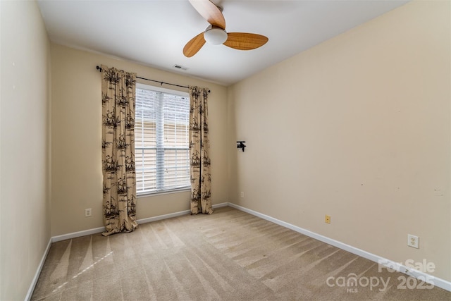 unfurnished room with visible vents, carpet floors, baseboards, and ceiling fan