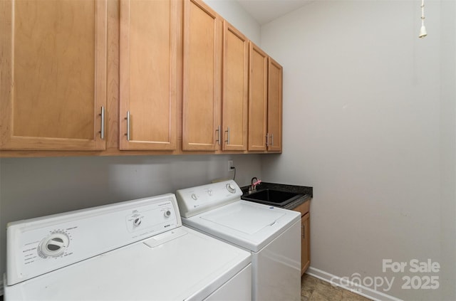 laundry area with a sink, baseboards, cabinet space, and independent washer and dryer