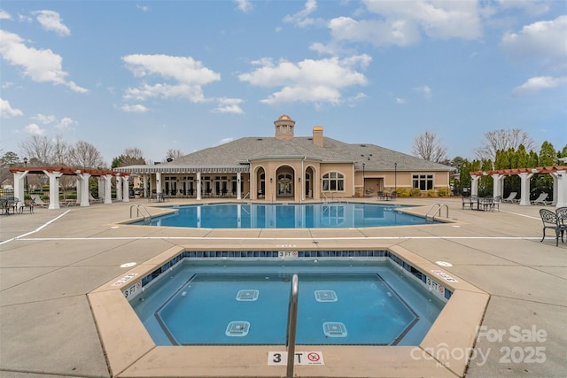 pool with a patio area, a community hot tub, and a pergola