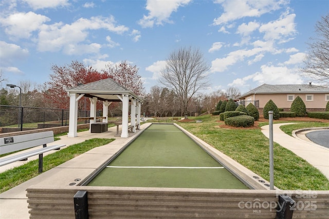 view of home's community with a gazebo, fence, and a lawn