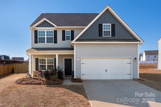 view of front of home with driveway, a garage, covered porch, fence, and board and batten siding