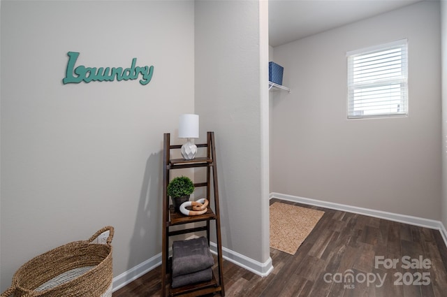 living area featuring baseboards and wood finished floors