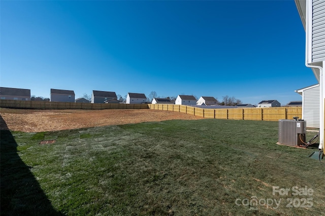 view of yard featuring a fenced backyard and central AC unit