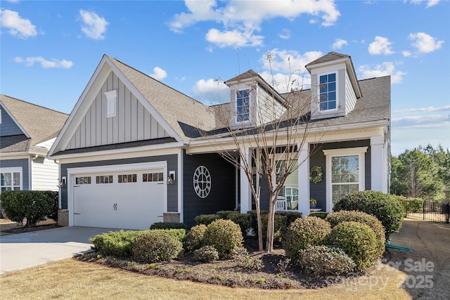 view of front of home featuring roof with shingles, concrete driveway, board and batten siding, and an attached garage