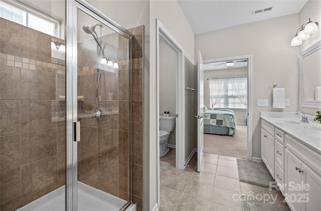 bathroom with a healthy amount of sunlight, a shower stall, visible vents, and toilet