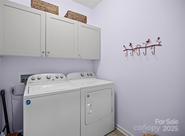 laundry room with washer and clothes dryer and cabinet space