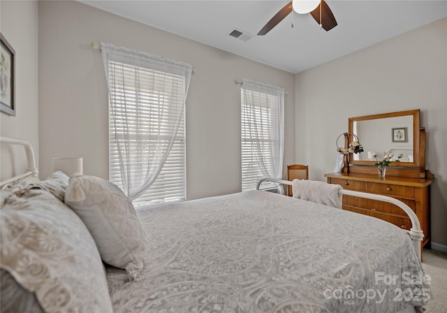 bedroom with ceiling fan, carpet, and visible vents