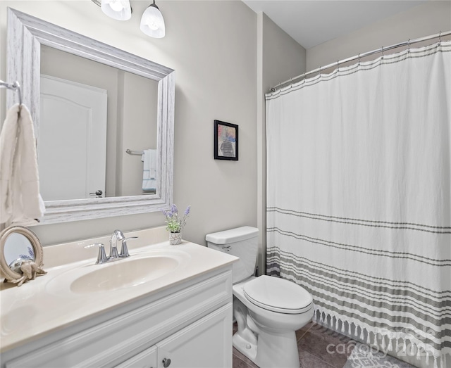 full bath featuring tile patterned flooring, vanity, and toilet