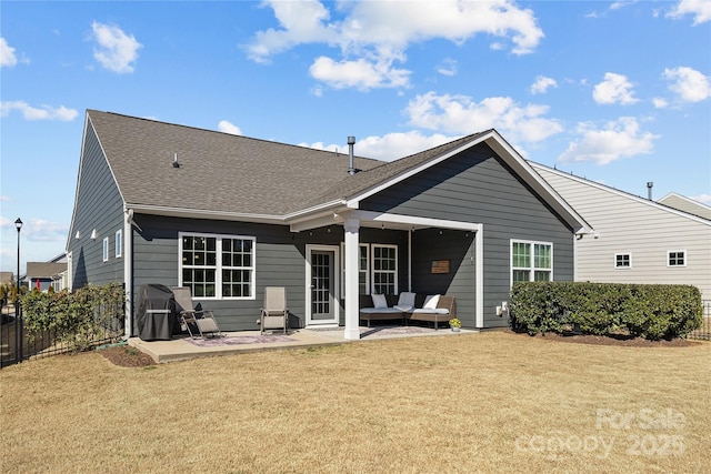 rear view of house with fence, a lawn, and a patio