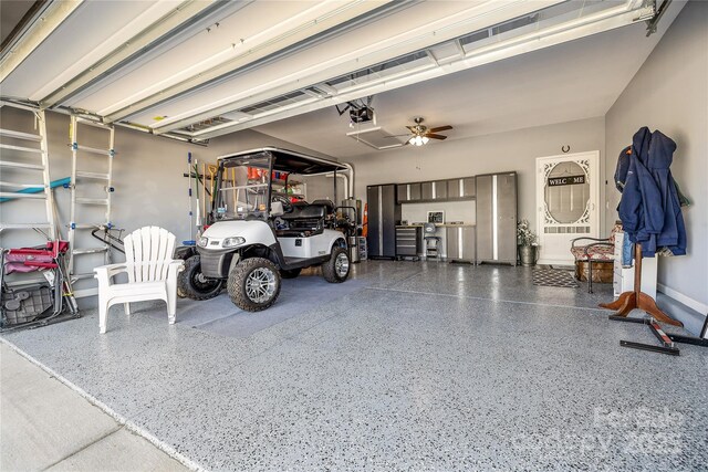 garage featuring a garage door opener and a ceiling fan