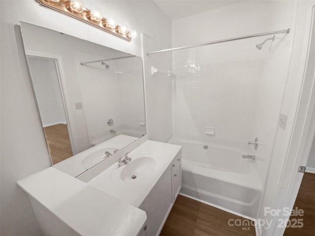 full bathroom featuring vanity, wood finished floors, and bathing tub / shower combination