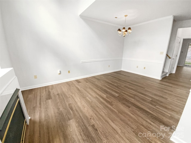 interior space featuring a chandelier, crown molding, baseboards, and wood finished floors