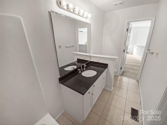 bathroom featuring tile patterned flooring, visible vents, vanity, and toilet