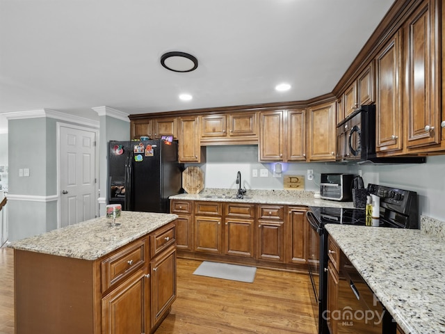 2200 Peninsula Ave, Shelby, NC 28150 - kitchen featuring black appliances, light wood-style flooring, ornamental molding, light stone countertops, and a kitchen island
