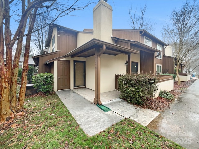 rear view of property featuring a chimney