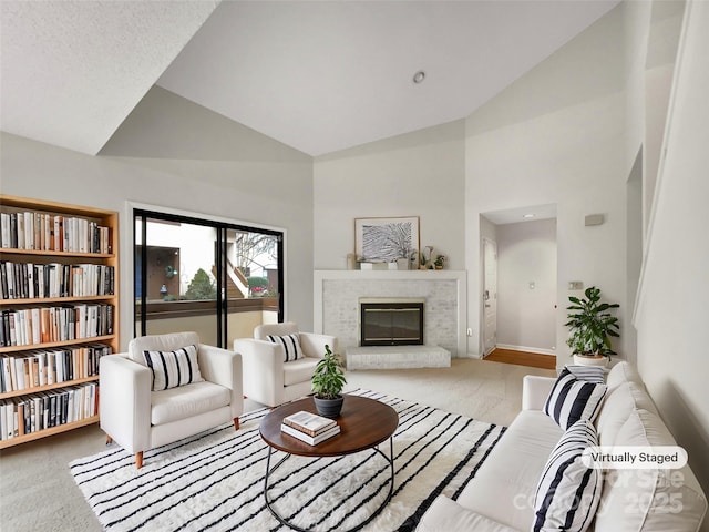 carpeted living room featuring high vaulted ceiling, a fireplace, and baseboards