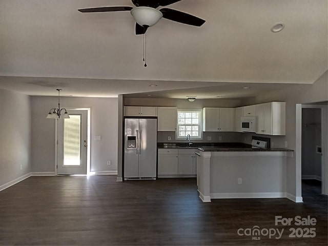 kitchen featuring dark wood-style flooring, dark countertops, white microwave, white cabinetry, and stainless steel fridge with ice dispenser