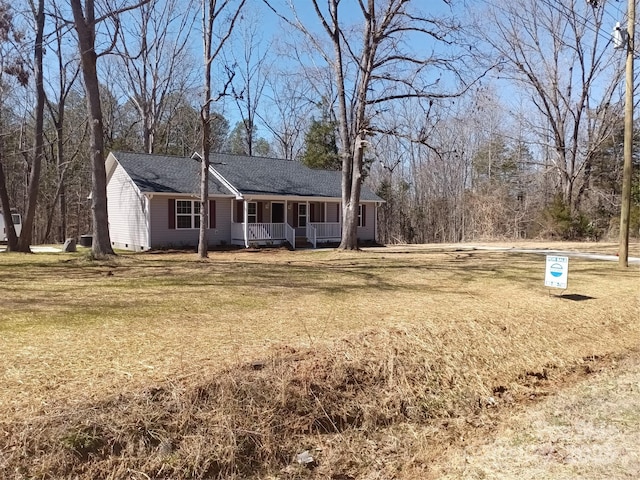 ranch-style house featuring covered porch, crawl space, a front lawn, and a chimney