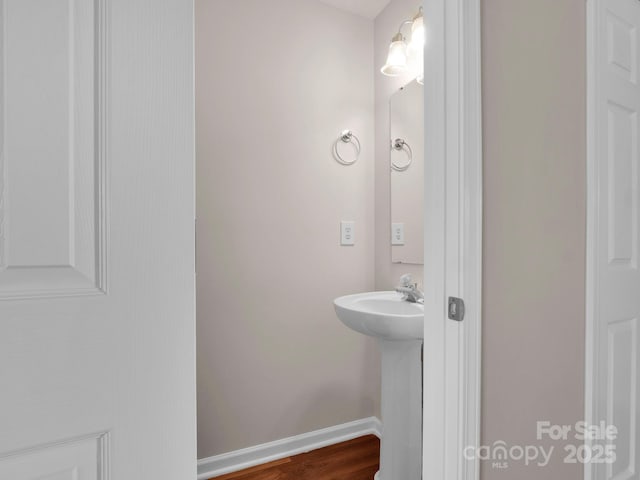 bathroom featuring a sink and baseboards