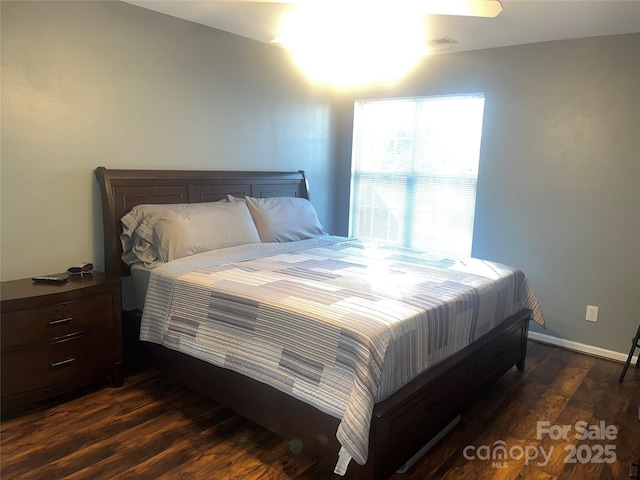 bedroom with dark wood-style floors and baseboards