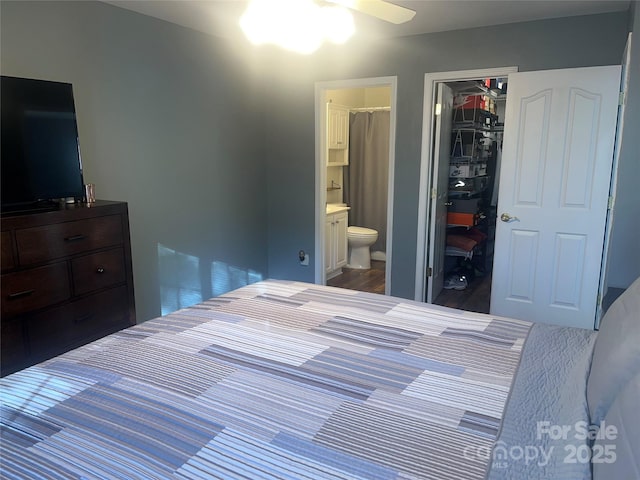 bedroom featuring a walk in closet, a closet, and ensuite bathroom