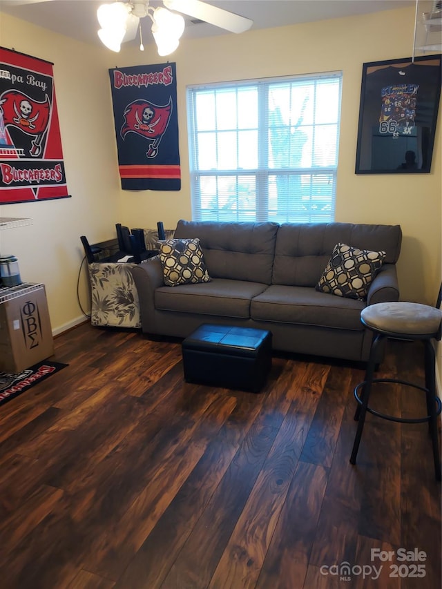 living area with wood finished floors and a ceiling fan