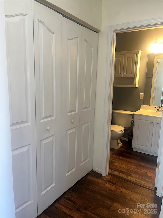 bathroom with vanity, toilet, and wood finished floors