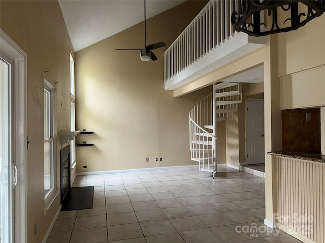 interior space with stairs, high vaulted ceiling, and tile patterned floors