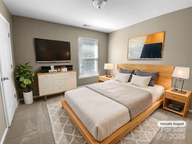 bedroom with visible vents and light colored carpet